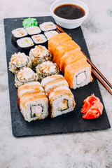 Delicious Assorted Sushi Set Sushi Maki - Eel Maki and Philadelphia Roll Sushi, Roll with avocado and hot fried rolls, ginger, wasabi, soy sauce. Copy Space for text. Asian or Japanese food concept