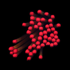 Red match heads on a black background