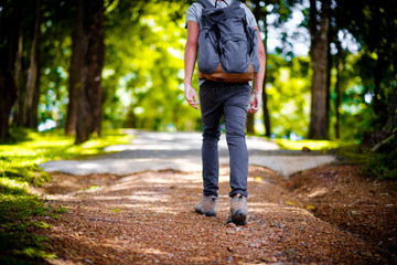 Fototapeta premium Man traveler traveling walking with backpack at the jungle on holiday at weekend on background nature view