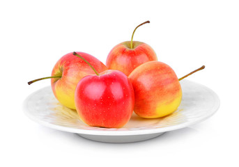 red dwarf apple in white plate isolated on white background