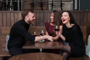 Funny company conversation in bar. Happy smiling people together, after work relaxation. Pleasant communication with red wine, fun concept