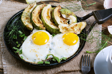 Home-made Breakfast - scrambled eggs, zucchini slices and black coffee.