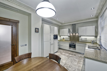 Modern design white kitchen in a spacious apartment.