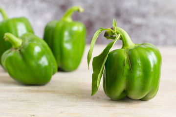 Green bell peppers from the garden on wooden table