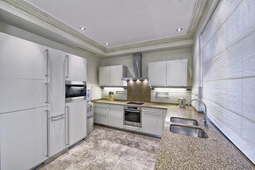 Modern design white kitchen in a spacious apartment.