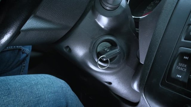 Starting car engine. a man's hand drives a car key