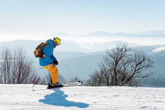 Skier enjoying skiing in mountains on a sunny winter day copyspace recreation active sport seasonal resort sportspeople adrenaline extreme concept