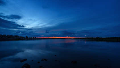 The sky at sunset reflected in the water of the lake.
