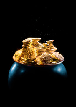 pot full of gold coins on a dark background / saint patricks day concept