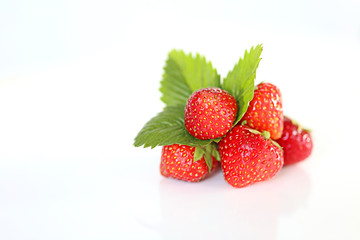 strawberries with leaves on white background. strawberry harvest