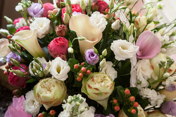 Beautifully decorated bouquet of roses and blue flowers