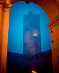 Civic Tower at Città Alta in a foggy day  - medieval old town - Bergamo Italy