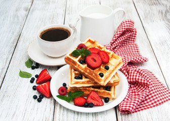 waffles with strawberries,  blueberry and coffee