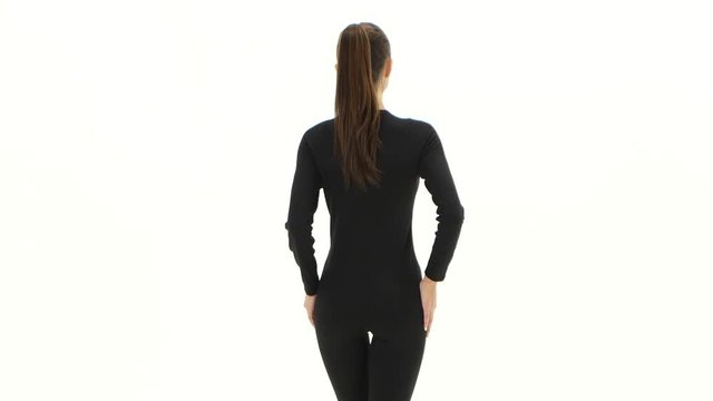 Girl advertises clothes. White background. Back view