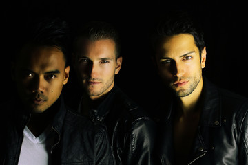 three beautiful vampires posing on a black background