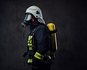 Fototapeta premium Firefighter dressed in uniform and an oxygen mask.