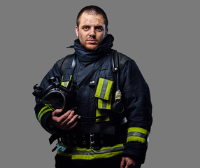 Naklejka premium Studio portrait of a male dressed in a firefighter uniform.
