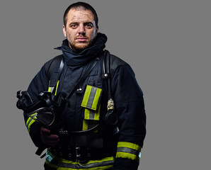 Obraz premium Studio portrait of a male dressed in a firefighter uniform.