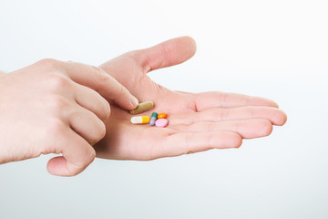 Pills in hand isolated on white background