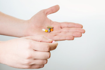 Pills in hand isolated on white background