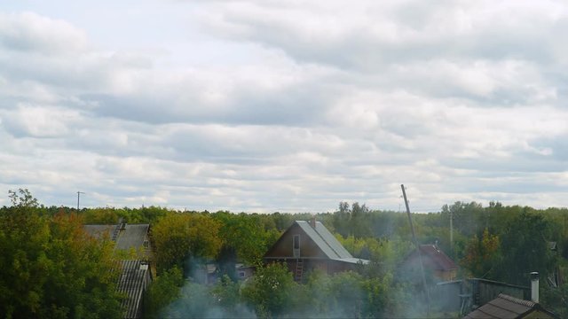 village scape. Cloud timelaps. cloud above wooden cottage and greenery