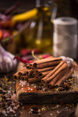 Whole cinnamon stocks on wooden boar. Spices concept