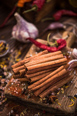 Whole cinnamon stocks on wooden boar. Spices concept