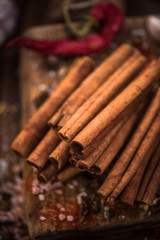 Whole cinnamon stocks on wooden boar. Spices concept