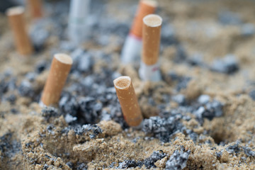 Smoked Cigarettes Butts in ashtray closed up, healthcare concept