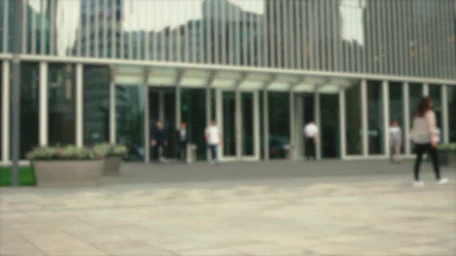 Seoul - July 2017: People walking in front of entrance to office building. Defocused look