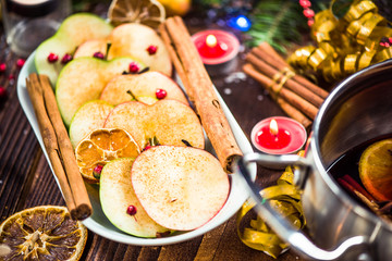Spiced apples with cinnamon on Christmas festive table