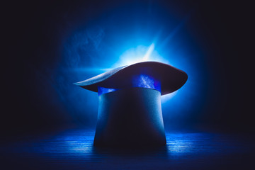 Magician hat on stage floor with dramatic lighting