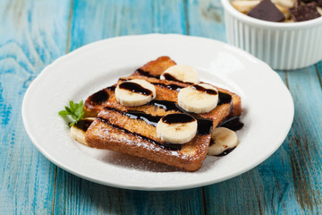 Traditional, delicious, sweet French toast with fruit and butter.