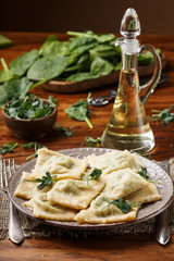 ravioli with spinach and ricotta cheese. Parmesan and oil. in a plate
