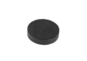 activated charcoal tablet isolated on white background
