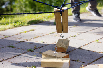 Obraz premium Wooden Blocks Being Lifted By Ropes