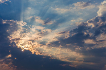 Naklejka na ściany i meble rays of the sun make their way through dramatic clouds