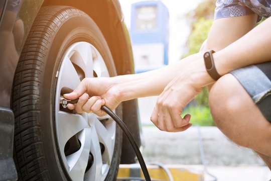 Close Up Hand Man Car Parking A Check The Tire Fill Up The Air For Safe Driving On The Go.