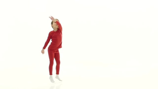 Child jumps up and has fun. White background. Slow motion
