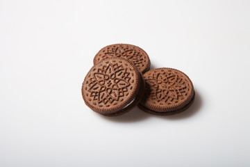 Chocolate cookies with cream filling on a light background in the studio