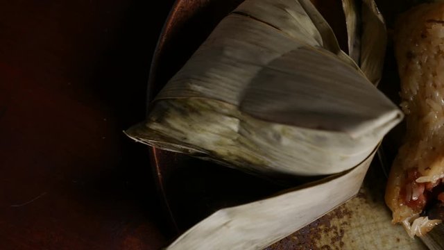 'Zongzi' or 'bakcang', 'bacang' a Chinese traditional food made of glutinous rice  with different fillings and wrapped in bamboo or large leaves.