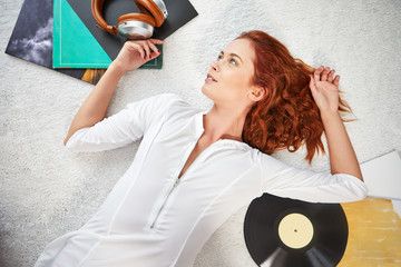 the image of resting sexy woman listening to vinyl
