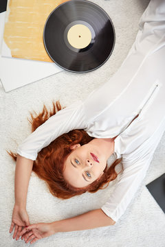 the image of resting sexy woman listening to vinyl