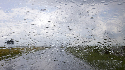 Driving car in the rain on wet road