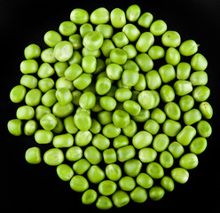 Green peas on a black background