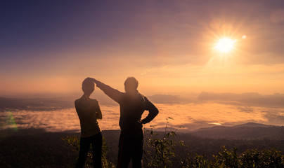 Fototapeta premium Hiking couple happy to reach the top of a mountain
