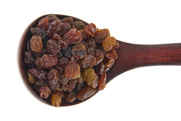 Raisins in a wooden spoon isolated on white background