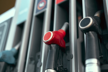 close up nozzle fuel in gas station, transport and business concept