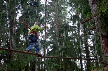 the boy passes the obstacle course in the rope town