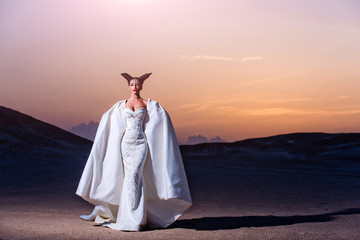 Bride in sand dunes on mountain landscape